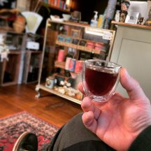 holding a glass with tea from Dinki
